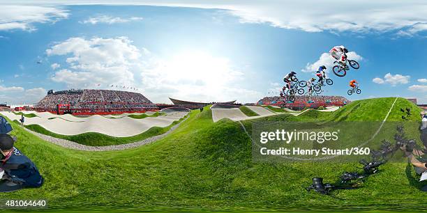 View of the BMX track as competitors take to the air during a heat on Day 14 of the London 2012 Olympic Games at the BMX Track on August 10, 2012 in...