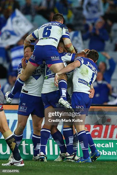 The Bulldogs celebrate after Josh Jackson of the Bulldogs scoed a try during the round 19 NRL match between the Parramatta Eels and the Canterbury...