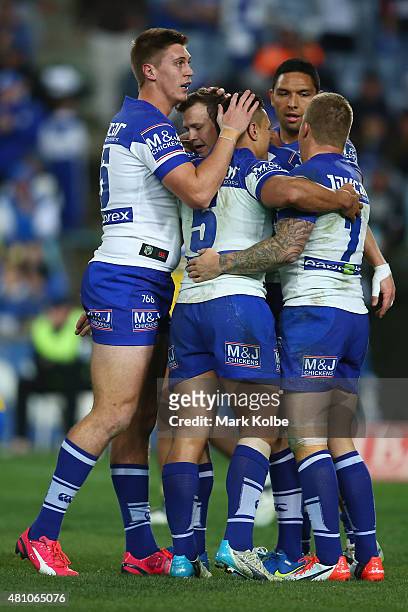 Shaun Lane, Brett Morris, Sam Perrett, Curtis Rona and Trent Hodkinson of the Bulldogs celebrate after Morris scored a try during the round 19 NRL...