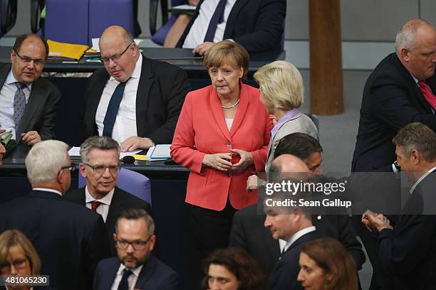 German Chancellor Angela Merkel waits to cast her ballot during votes over the third EU financial aid package to Greece at an extraordinary session...