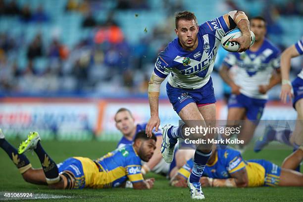 Josh Reynolds of the Bulldogs makes a break during the round 19 NRL match between the Parramatta Eels and the Canterbury Bulldogs at ANZ Stadium on...