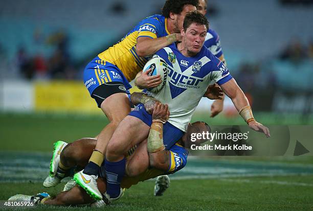 Josh Jackson of the Bulldogs is tackled during the round 19 NRL match between the Parramatta Eels and the Canterbury Bulldogs at ANZ Stadium on July...