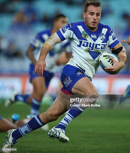 Josh Reynolds of the Bulldogs makes a break during the round 19 NRL match between the Parramatta Eels and the Canterbury Bulldogs at ANZ Stadium on...