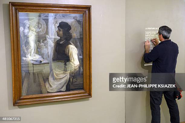 Employees prepare the exhibtion "Du romantisme à l'impressionisme" dedicated to the paintings by French artist Alfred Bellet du Poisat at the...