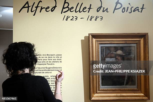 Person looks at paintings by French artist Alfred Bellet du Poisat at the Bourgoin-Jallieu museum on March 28 during the exhibition "Du romantisme à...