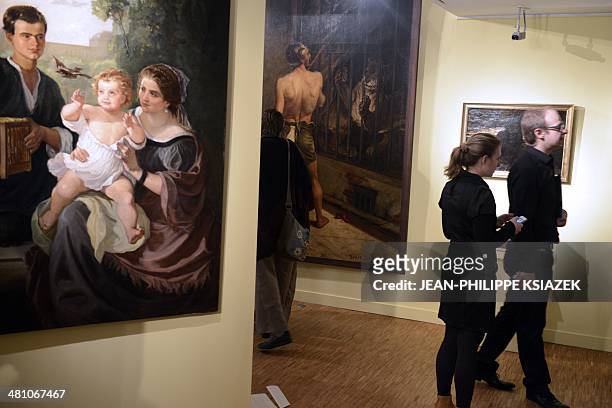 People look at paintings by French artist Alfred Bellet du Poisat at the Bourgoin-Jallieu museum on March 28 during the exhibition "Du romantisme à...