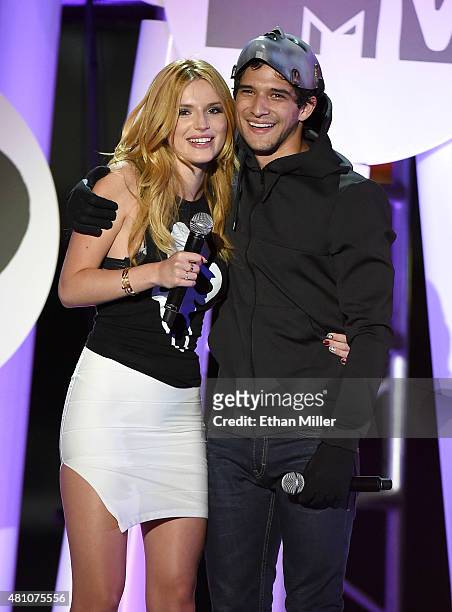 Actress Bella Thorne and actor Tyler Posey co-host the MTV Fandom Fest San Diego Comic-Con at PETCO Park on July 9, 2015 in San Diego, California.