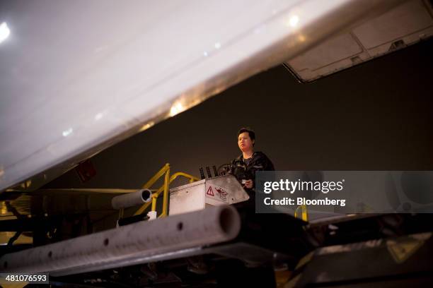 An employee drives an FMC Technologies Commander 15i cargo loader during ground operations at the FedEx Corp. Asia Pacific Region hub in Guangzhou,...