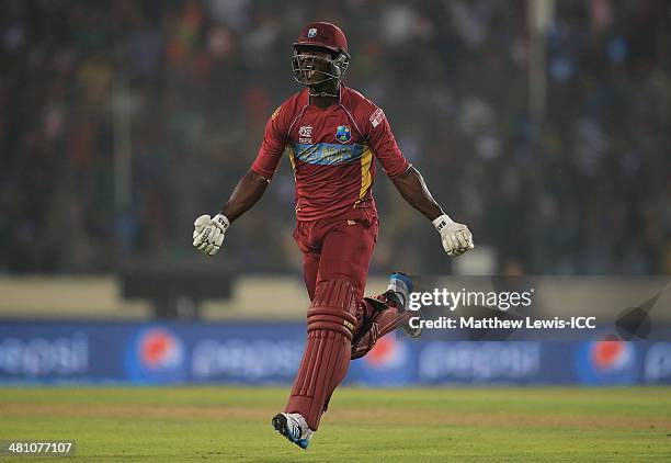 Darren Sammy of the West Indies celebrates hitting the winning runs to defeat Australia during the ICC World Twenty20 Bangladesh 2014 match between...