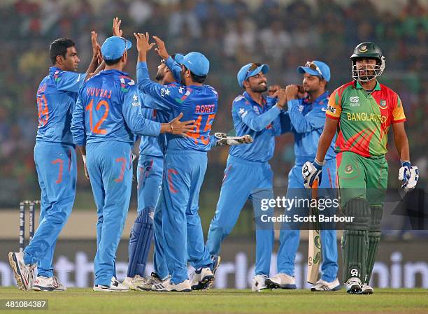 Ravichandran Ashwin of India is congratulated by his teammates after dismissing Tamim Iqbal of Bangladesh during the ICC World Twenty20 Bangladesh...