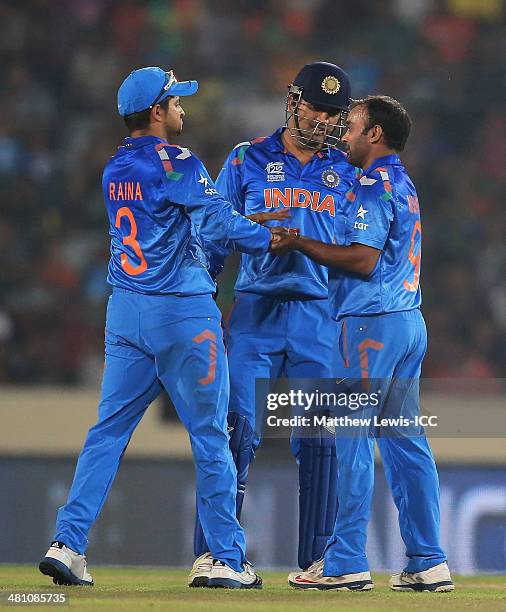 Amit Mishra of India is congratulated by MS Dhoni, after bowling Anamul Haque of Bangladesh during the ICC World Twenty20 Bangladesh 2014 match...