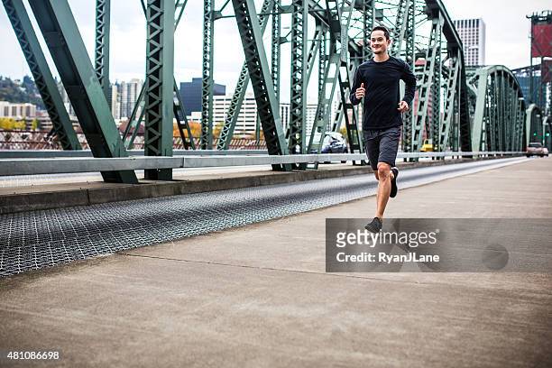man running in downtown portland - portland oregon downtown stock pictures, royalty-free photos & images