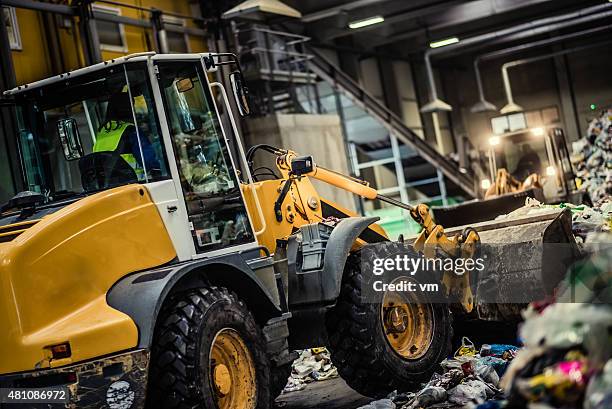 earth mover in the garbage dump - bulldozer stock pictures, royalty-free photos & images