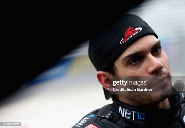 German Quiroga, driver of the NET10 Wireless Toyota, looks on in the garage area during practice for the NASCAR Camping World Truck Series Kroger 250...