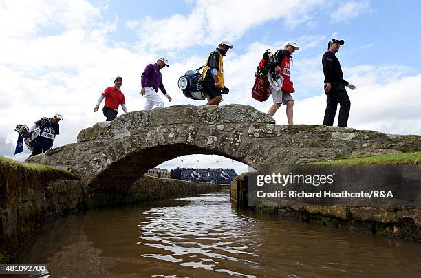 Padraig Harrington of Ireland, caddie Ronan Flood, caddie Ken Herring, Marc Warren of Scotland, Wenchong Liang of China and caddie Koji Manabe walk...