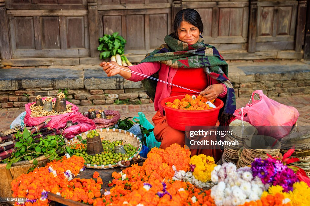 Nepali street seller selling flowers and vegetables in Patan, Nepal