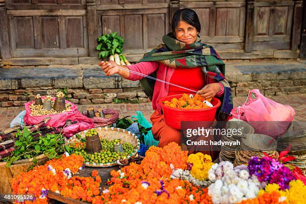 nepali street seller selling flowers and vegetables in patan, nepal - nepal women stock pictures, royalty-free photos & images