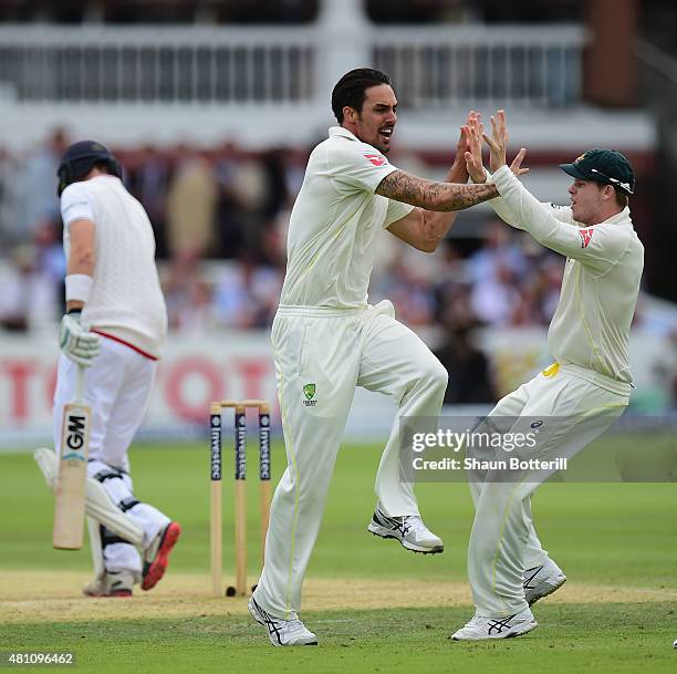 Mitchell Johnson of Australia celebrates after taking the wicket of Joe Root of England during day two of the 2nd Investec Ashes Test match between...