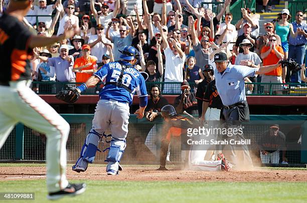 Gregor Blanco of the San Francisco Giants slides safely into home plate before the tag of Ramon Hernandez of the Kansas City Royals during a game at...