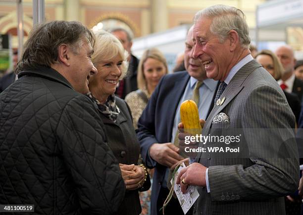 Camilla, Duchess of Cornwall and Prince Charles, Prince of Wales share a joke as Raymond Blanc looks on as the Duchess holds a squash during The...