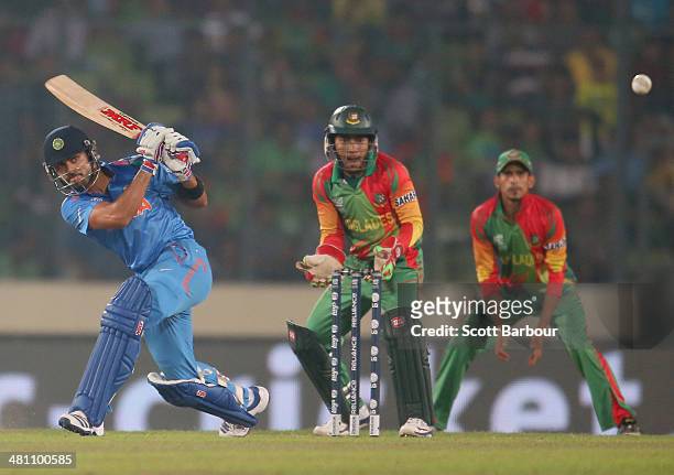 Virat Kohli of India bats as Mushfiqur Rahim of Bangladesh looks on during the ICC World Twenty20 Bangladesh 2014 match between Bangladesh and India...