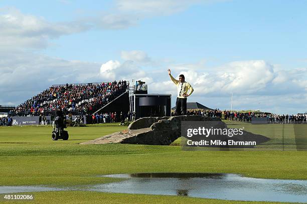 Sir Nick Faldo of England waves to the crowd as he stands on Swilcan Bridge during the second round of the 144th Open Championship at The Old Course...