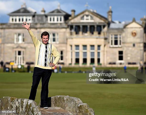 Sir Nick Faldo of England waves to the crowd as he stands on Swilcan Bridge during the second round of the 144th Open Championship at The Old Course...