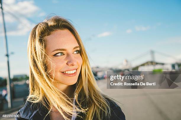 cheerful young woman cycling in the park - woman moscow stock pictures, royalty-free photos & images