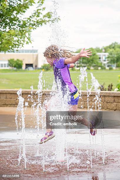 girl playing in fountain at splash park in summer - girl wet stock pictures, royalty-free photos & images