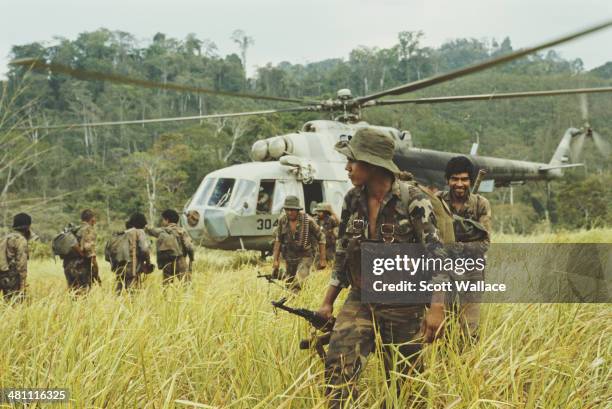 Troops of the Sandinista Popular Army , taking part in a heliborne operation against the Contra rebels, in Nicaragua near the border with Honduras,...