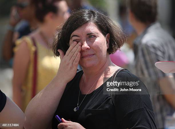 Jess Marke wipes a tear while visiting the Emanuel AME Church with her family, on the one-month anniversary of the mass shooting on July 17, 2015 in...