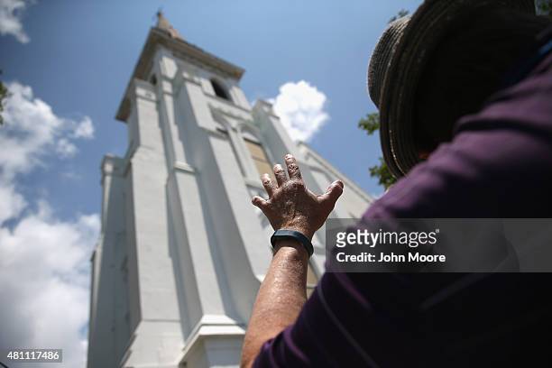 People pray in front of the Emanuel AME Church on the one-month anniversary of the mass shooting on July 17, 2015 in Charleston, South Carolina....
