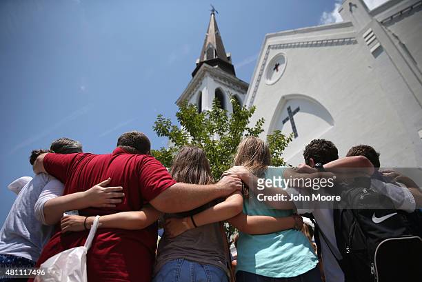 Church youth group from Dothan, Alabama prays in front of the Emanuel AME Church on the one-month anniversary of the mass shooting on July 17, 2015...
