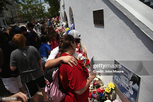 Visitors pay their respects in front of the Emanuel AME Church on the one-month anniversary of the mass shooting on July 17, 2015 in Charleston,...