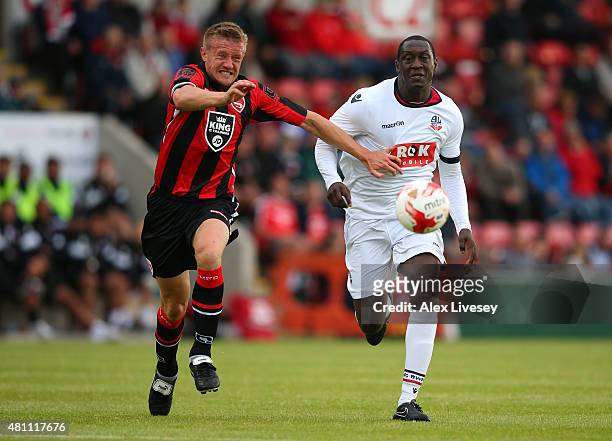 Andy Parrish of Morecambe and Emile Heskey of Bolton Wanderers battle for the ball during a Pre Season Friendly match between Morecambe and Bolton...