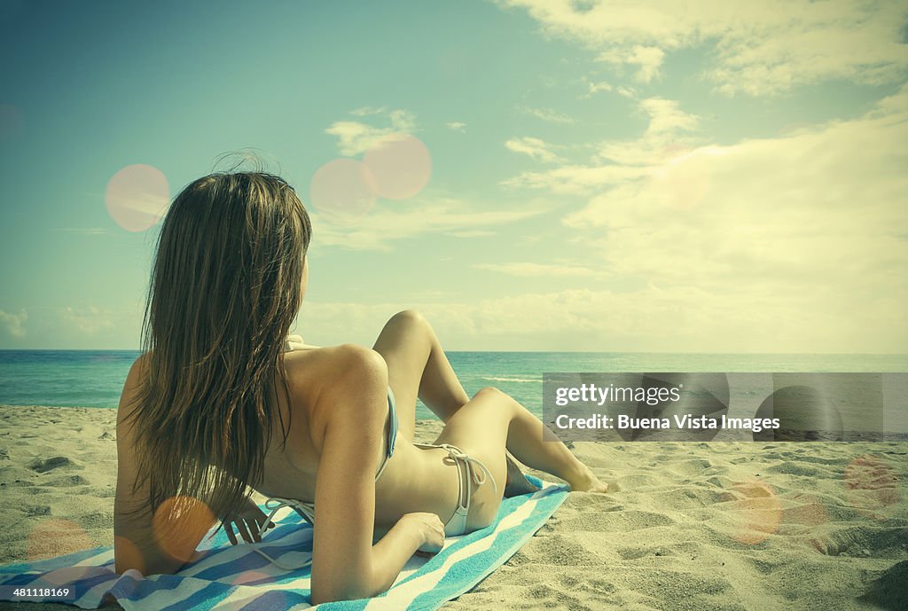 Young woman lying on the beach