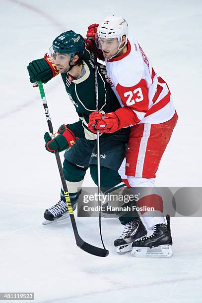 Matt Moulson of the Minnesota Wild and Brian Lashoff of the Detroit Red Wings position themselves in front of the net defended by the Detroit Red...