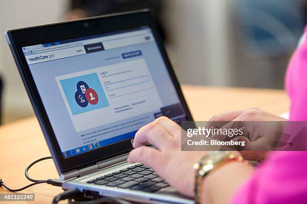 Marketplace guide Stephanie Cantres works on the Healthcare.gov federal enrollment website as she helps a resident sign up for a health insurance...