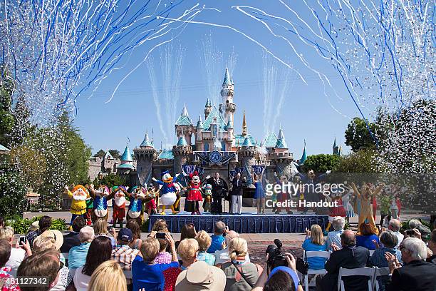 In this handout photo provided by Disney parks, Mickey Mouse and his friends celebrate the 60th anniversary of Disneyland park during a ceremony at...