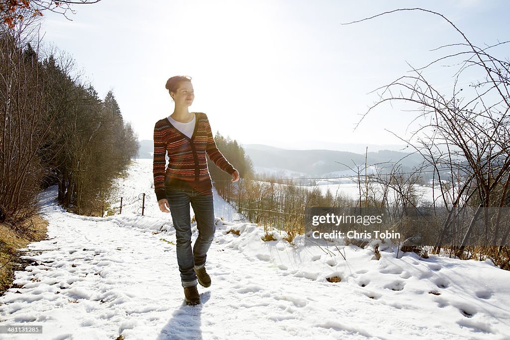 Woman walking on a snowy path