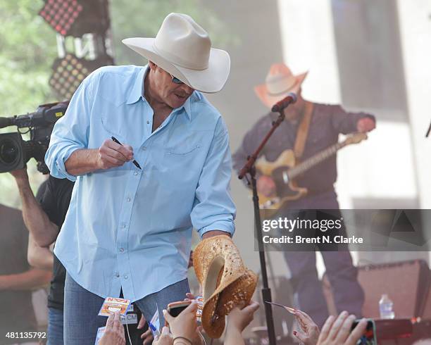 Singer/songwriter Alan Jackson signs memorbilia for fans during his performance live on NBC's "Today" held at Rockefeller Plaza on July 17, 2015 in...
