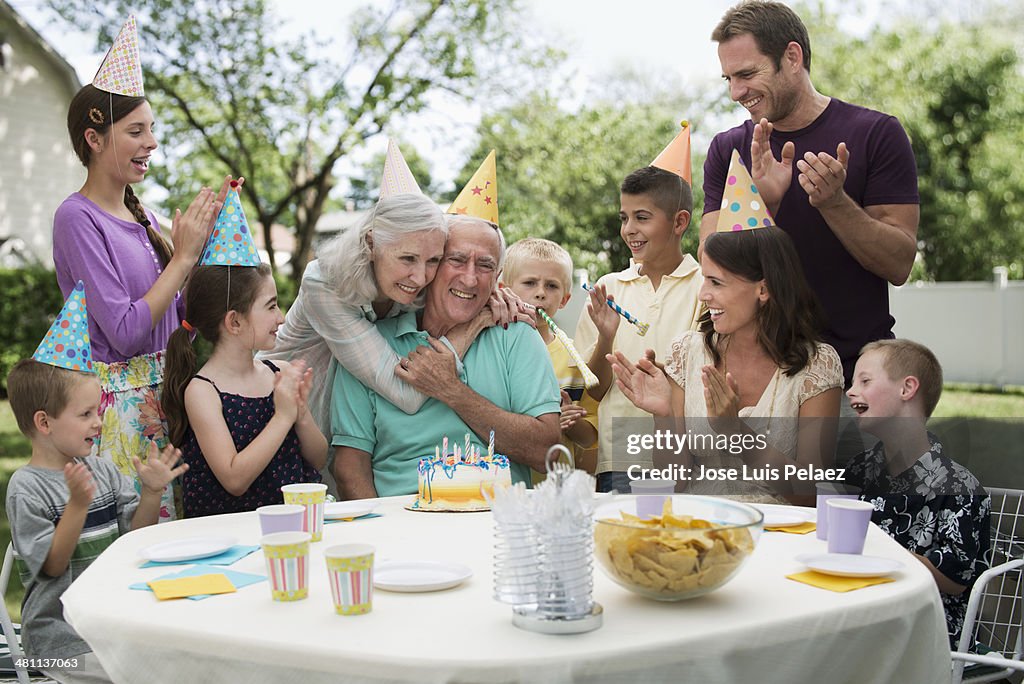 Family celebraring grandfather's birthday