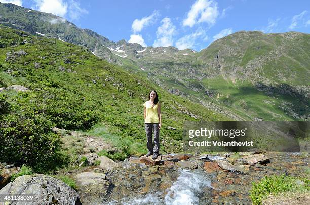 girl hiking in the mountains next to a stream - ax les thermes stock-fotos und bilder