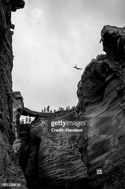 In this handout image provided by Red Bull, Anna Bader of Germany dives from a 20 metre cliff during the first training session prior to the fifth...