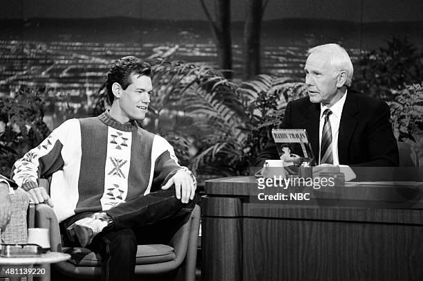 Pictured: Musical guest Randy Travis during an interview with host Johnny Carson on December 5, 1990 --