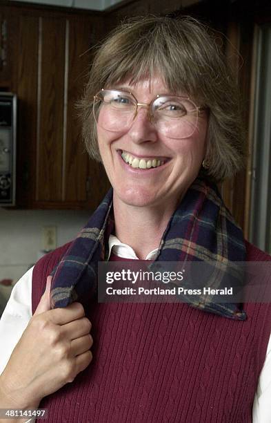 Staff Photo by John Ewing, Wed, Sep 26, 2001: Betsy Hanscom demonstrates how she uses one of her MaineWarmers as a warm collar under her coat on cold...