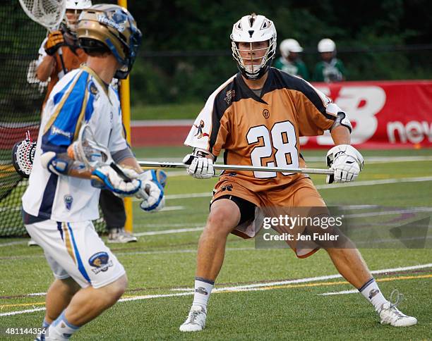 Will Koshansky of the Rochester Rattlers defends against Mike Chanenchuk of the Charlotte Hounds at Eunice Kennedy Shriver Stadium on July 17, 2015...