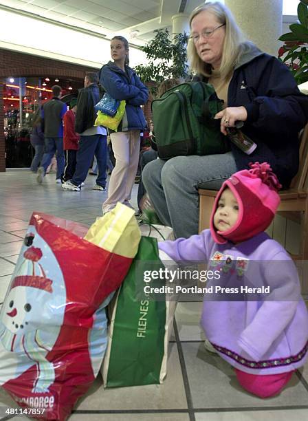 Staff Photo by Jill Brady, Friday, December 26, 2003: Pat Donahue of Kennebunk takes a break with her granddaughter, Khadijiah Kagoni, 10 mos., of...