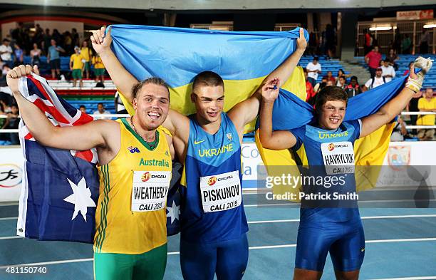 Hlib Piskunov of the Ukraine, Mykhailo Havryliuk of the Ukraine and Ned Weatherly of Australia celebrate after the Boys Hammer Throw Final on day...