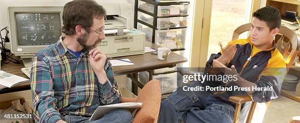 Staff Photo by Gordon Chibroski, Thursday, March 28, 2002: Nicaraguan Sign Language Projects, Inc. Coordinator, James Shepard-Kegl, is told by Barney...